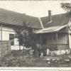 Malvina in back of her house.  You can see her by a well in the backyard