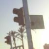 Sign showing a hand pushing a button (to change the light for crossing the street).