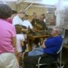 County Fair, a rabbit sits on the table and people can pet it